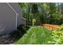 The house boasts a well-kept lawn and a classic wooden fence at 602 Black Maple Dr, Kannapolis, NC 28081