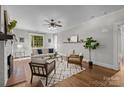 Bright living room with hardwood floors, neutral walls, fireplace, large windows, and modern decor at 700 Oakland Ave, Charlotte, NC 28204