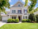 Charming two-story home with landscaped yard, covered porch, and attached two car garage at 79411 Ridgehaven Rd, Indian Land, SC 29720