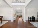 Open foyer features hardwood floors, decorative columns, and a view into the living spaces beyond at 79411 Ridgehaven Rd, Indian Land, SC 29720