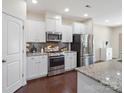 Modern kitchen with stainless steel appliances, granite countertops, and white cabinets at 79411 Ridgehaven Rd, Indian Land, SC 29720