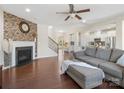 Spacious living room with a stacked stone fireplace and dark hardwood flooring at 79411 Ridgehaven Rd, Indian Land, SC 29720