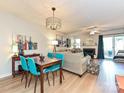 Bright living room with modern lighting, fireplace, and sliding door to outdoor area at 9305 Four Mile Creek Rd, Charlotte, NC 28277