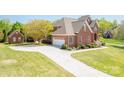 Lovely brick home features an attached garage, mature trees and well-maintained lawn at 1103 Hillcrest Ridge Dr, Salisbury, NC 28146