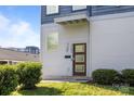 A modern front door is accented by green bushes at 1121 N Alexander St, Charlotte, NC 28206
