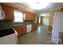 Traditional style kitchen with granite counters, tiled backsplash, tile floors, cabinets and white appliances at 1174 Orchard Dr, Fort Mill, SC 29715