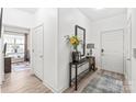 Entryway with console table, mirror, flowers and rug at 12357 Copper Mountain Blvd, Charlotte, NC 28277