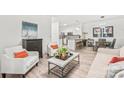 Bright living room with modern decor and an open floor plan leading to the kitchen at 12357 Copper Mountain Blvd, Charlotte, NC 28277