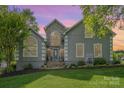 Charming two-story home with stone accents, a well-manicured lawn, and beautiful landscaping at 130 Hopedale Ct, Mooresville, NC 28117