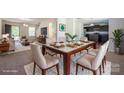 A staged dining room features a glass table, seating for six, and decorative serving ware at 1430 Eastway Dr, Dallas, NC 28034