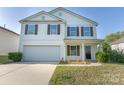 Traditional two-story home features a 2-car garage, neutral siding, and a well-maintained yard at 1430 Eastway Dr, Dallas, NC 28034