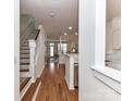 Bright foyer with hardwood floors, white trim, and an open staircase, offering a warm and inviting atmosphere at 1568 Cleveland Ave, Charlotte, NC 28203