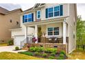 Inviting front porch with brick facade, decorative iron railings, and stylish columns at 1588 Trentwood Dr, Fort Mill, SC 29715