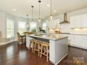 Bright, open kitchen with granite countertops, stainless appliances, and a breakfast nook at 18721 Dumbarton Oaks Dr, Cornelius, NC 28031