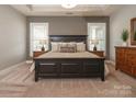 Serene main bedroom with a tray ceiling, plush carpet, and ample natural light at 18721 Dumbarton Oaks Dr, Cornelius, NC 28031