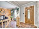 Inviting foyer featuring wood flooring, a decorative front door, and an open view to the living area at 1938 Hickory Dr, Lancaster, SC 29720