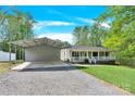 Lovely ranch home features a quaint porch, matching carport, and pristine lawn at 2315 Collins Dr, Albemarle, NC 28001