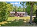 Charming one-story home featuring a brick chimney, well-manicured lawn, and inviting curb appeal at 2615 Toddville Rd, Charlotte, NC 28214