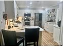 Bright kitchen featuring white cabinets, stainless steel appliances, and a stylish breakfast bar at 3063 Wimbledon Ln, Rock Hill, SC 29732