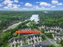 Aerial view of townhomes near a lake, showcasing community layout and proximity to the water at 314 Wave Crest Dr, Tega Cay, SC 29708