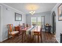 Traditional dining room with wood floors, natural light, classic decor, and comfortable seating for gatherings at 335 Ridgewood Dr, Mt Ulla, NC 28125