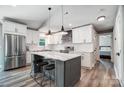 Bright kitchen featuring a gray kitchen island, modern appliances, and sleek white cabinetry at 3612 Cobbleridge Dr, Charlotte, NC 28215