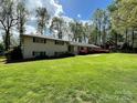 Ranch-style home boasting a lush green lawn and mature landscaping at 3713 Saint Regis Dr, Gastonia, NC 28056