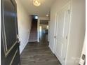 Inviting foyer featuring hardwood floors, stairs to the upper level, and a glimpse of the kitchen at 3776 Yorkshire Pl, Terrell, NC 28682