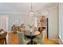Dining area with hardwood floors, elegant lighting, and seamless access to the kitchen at 3819 Gleneagles Rd, Charlotte, NC 28210
