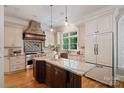 Gourmet kitchen features granite countertops, custom cabinets, and stainless steel appliances at 3819 Gleneagles Rd, Charlotte, NC 28210