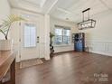 Elegant living room with hardwood floors, coffered ceilings, and ample natural light from large windows at 4606 Gatesmills Ave, Charlotte, NC 28213