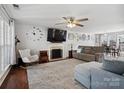 Spacious living room with fireplace, ceiling fan, and ample natural light at 4665 Madeline Dr, Rock Hill, SC 29732