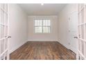 Bright office space with hardwood floors, a large window, and minimalist decor, perfect for productivity at 5043 Antebellum Dr, Iron Station, NC 28080
