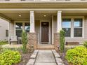 Inviting front porch with seating area and decorative columns at 6433 Raffia Rd, Charlotte, NC 28277