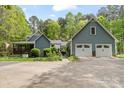 Lovely home with a two-car garage, set amidst a backdrop of mature trees at 705 Normandy Rd, Mooresville, NC 28117