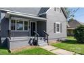 Quaint home featuring a covered porch with a black railing and freshly painted gray stairs at 71 14Th Se St, Hickory, NC 28602