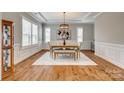 Formal dining room with hardwood floors, neutral walls, and elegant lighting, perfect for entertaining guests at 7157 Sumters Camp Trl, Indian Land, SC 29707