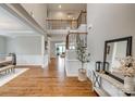 Bright foyer with hardwood floors, elegant wainscoting, and a staircase leading to the upper level at 7157 Sumters Camp Trl, Indian Land, SC 29707