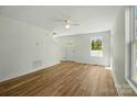 Bright living room features hardwood floors, natural light and an open doorway leading outside at 76 Snyder Ne Ct, Concord, NC 28025