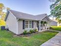 Well-maintained home featuring a side entrance, manicured lawn, and lovely landscaping in a quiet neighborhood at 833 Generation Ln, Clover, SC 29710