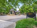 View of the gated entrance to The Club at Longview featuring a stone guardhouse and elegant signage at 8710 Chewton Glen Dr, Waxhaw, NC 28173