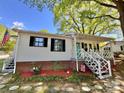 A cozy home with a delightful porch, complete with an American flag and attractive brick accents at 903 Lakeview St, Kannapolis, NC 28083
