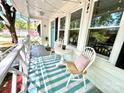 Inviting front porch featuring stylish seating, a striped rug, and charming string lights at 903 Lakeview St, Kannapolis, NC 28083