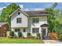 Charming two-story home featuring a landscaped front yard with well-manicured bushes and a covered front porch at 908 Academy St, Charlotte, NC 28205