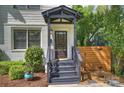 Inviting front porch with dark wood steps and a well-manicured bush at 908 Academy St, Charlotte, NC 28205