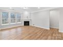 Bright living room featuring a fireplace, large windows, and hardwood floors at Tbd Boomer Ct # 2, Statesville, NC 28677