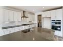 Close up of a modern kitchen island with a stainless steel sink and gray countertop at Tbd Boomer Ct # 3, Statesville, NC 28677