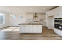 Modern kitchen with white cabinets, stainless steel appliances, large island, and ample counter space at Tbd Boomer Ct # 3, Statesville, NC 28677