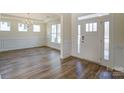 Bright living room with wood floors, crown molding, wainscotting, and a large window at Tbd Boomer Ct # 3, Statesville, NC 28677
