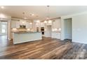 Spacious open-concept kitchen featuring white cabinets, stainless appliances and hard wood floors at Tbd Boomer Ct # 4, Statesville, NC 28677